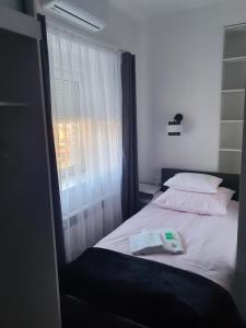 a bedroom with a white bed with a window at Comfort Stay, EV, Parking in Bolesławiec
