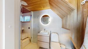 a small bathroom with a sink and a mirror at Levi Aurora Igloo in Levi