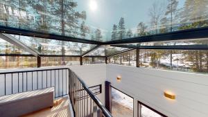 a glass house with a balcony with windows at Levi Aurora Igloo in Levi