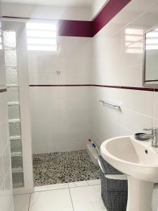 a bathroom with a sink and a shower at Cocoline in Vieux-Fort