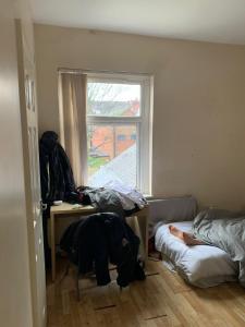 a room with two beds and a desk and a window at Luxury Room in villers street in Wyken