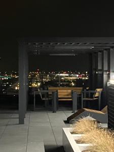 a patio with a view of the city at night at Warsaw Airport Wyścigi - City and Green View Apartment with free parking in Warsaw