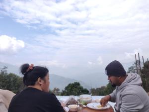 a group of people sitting at a table eating food at Art Mile Kalimpong in Kalimpong