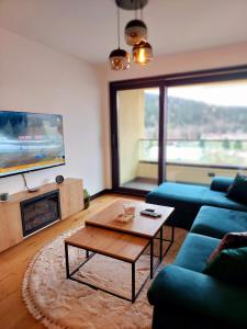 a living room with a couch and a coffee table at WinterHome2 in Bjelašnica