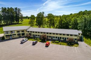 an aerial view of a building with cars parked in a parking lot at The Lodge at Poland Spring Resort in Poland Spring