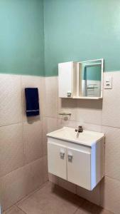 a bathroom with a white sink and a mirror at Casa Silandia, tu casa en Búzios in Búzios