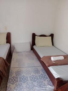 Un ou plusieurs lits dans un hébergement de l'établissement Pousada Acalanto