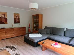 a living room with a couch and a table at Ferienwohnung "Erika" Rees am Niederrhein in Rees +34 photos