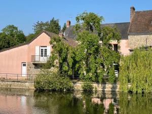 a house on the side of a river at Les Maisons d'Auré in Putanges