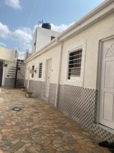 a white building with a window and a door at La Résidence in Lomé