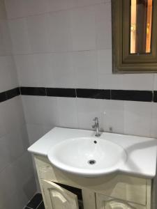 a bathroom with a white sink and a mirror at La Résidence in Lomé +11 photos