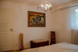 1 dormitorio con 1 cama y una pintura en la pared en Modern countryside apartment en Borlänge