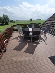 a patio with a table and chairs on a deck at Ferienwohnung 2 - a72142 in Wangerland