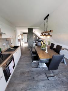 a kitchen and dining room with a table and chairs at Ferienwohnung 2 - a72142 in Wangerland