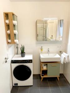 a small bathroom with a sink and a microwave at Ferienwohnung Am Kofel in Oberammergau