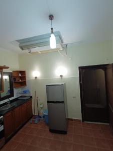 a kitchen with a refrigerator in the middle of a room at sahl hashesh makadi- hurghada- in Hurghada +20 photos
