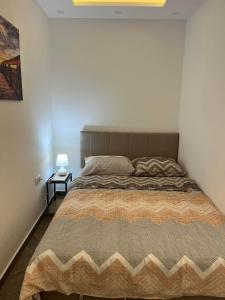 a bedroom with a large bed in a white wall at Surčin Centar apartment in Surčin