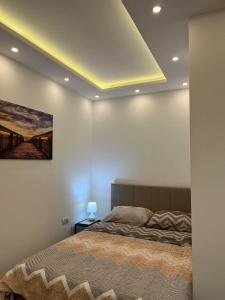 a bedroom with a bed and a painting on the wall at Surčin Centar apartment in Surčin