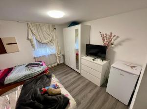 a small room with two beds and a television at double room for you in Hünxe