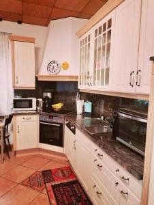 a kitchen with white cabinets and a sink at double room for you in Hünxe