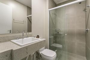 a bathroom with a sink and a toilet and a shower at Wi-Fi 250MB | Sea View | Pool #CA61 in Florianópolis