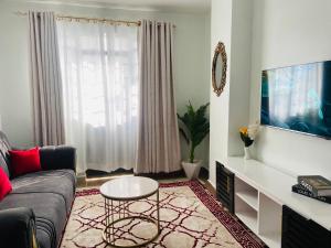 sala de estar con sofá y mesa en Luxurious furnished home thika road en Nairobi