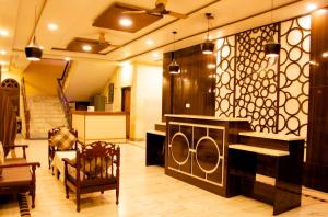 a living room with a couch and a piano at Hotel Pahuna Ghar in Nepālganj