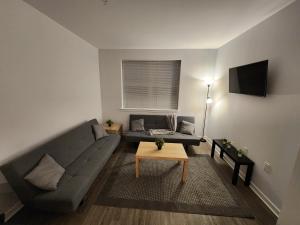 a living room with a couch and a table at Astonishing 2BR Apt Mins to NYC in Jersey City