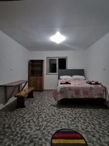 a bedroom with a bed and a desk in it at Refugio Kiñeco in Conguillio