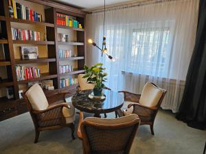 a room with a table and chairs and a book shelf at Ferienwohnung Renaissance in Backnang