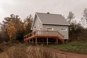 a large gray house with a deck on a hill at Le Crustacé 2 a 4 personnes in Nouvelle +19 photos