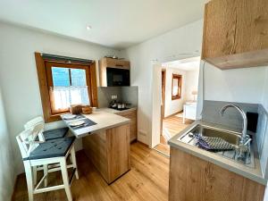 a small kitchen with a sink and a counter at Ferienwohnungen Roderer in Berchtesgaden +25 photos