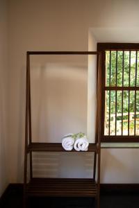 a shelf with towels on it next to a window at Woradi Solitude Bungalow in Talpe