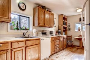 a kitchen with wooden cabinets and a white dishwasher at Hakuna Matata - 10 Minutes to Killington Lifts in West Bridgewater