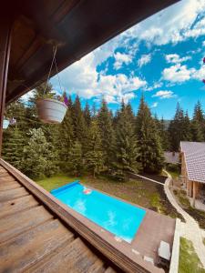 a view from the deck of a house with a swimming pool at Маєток Ліс і Гори in Bukovel