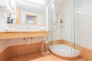 a bathroom with a shower and a sink at Biohotel Leutascherhof in Leutasch