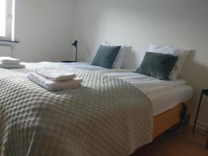 a bedroom with two beds with towels on them at Villa Hassel in Middelfart