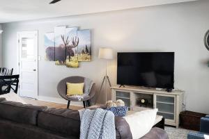 ein Wohnzimmer mit einem Sofa und einem Flachbild-TV in der Unterkunft Beautiful Colorado Home, Centrally Located! Great Yard! in Wheat Ridge