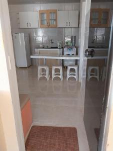 a kitchen with a table and four stools in it at Flats Temporada & Mensal in Aracaju