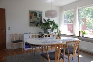 a kitchen and dining room with a table and chairs at Villa Hassel in Middelfart