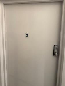 a door with a remote control attached to it at Room 3 • Double Bed in London King’s Cross in London