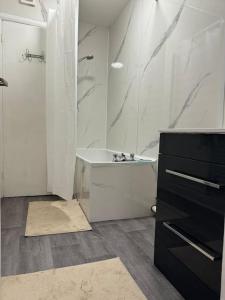 a white bathroom with a shower and a sink at Room 3 • Double Bed in London King’s Cross in London