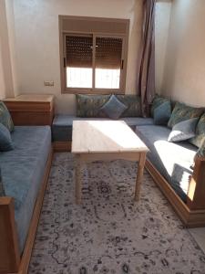 a living room with a couch and a table at Al-Nasr in Agadir