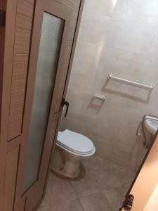 a bathroom with a toilet and a door open at Al-Nasr in Agadir