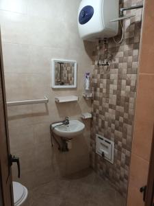a small bathroom with a sink and a toilet at Al-Nasr in Agadir