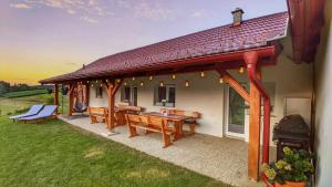 einem Pavillon mit Bänken und einem Grill auf einem Haus in der Unterkunft Holiday Home Rojko in Štrigova