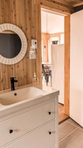 a kitchen with a white sink and a refrigerator at Le Martin Pecheur 2 à 4 personnes in Nouvelle
