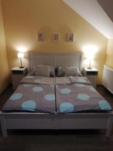 a bedroom with a large bed with two lamps at Pokoje Gościnne u Joli in Szczyrk