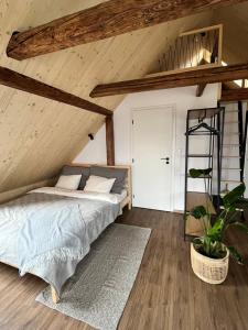 a bedroom with a bed in a attic at Sáňky Apartmány in Liberec