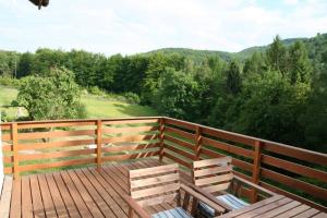 a wooden deck with two benches on top of it at Porąbka - nocleg w urokliwym miejscu in Porąbka